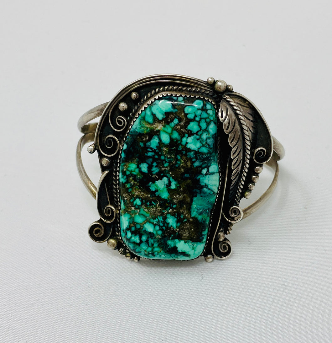 Heavy Navajo Cuff with Raindrops and Stampwork on Leaves Surrounding Stunning Turquoise Stone