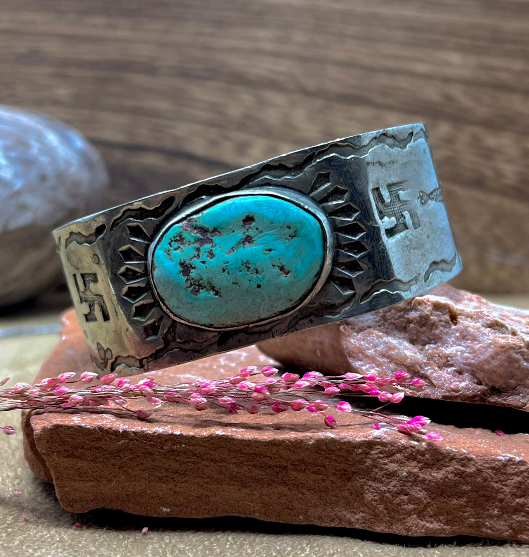 Early Navajo Cuff with whirling logs and light turquoise nugget