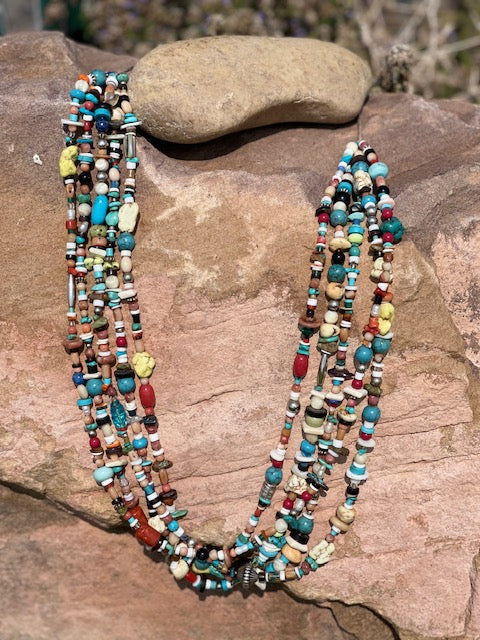 There is Turquoise, Coral, Hubble Glass Beads, Lapiz, Sterling Silver beads, and Stones all strung together on a braided 34
