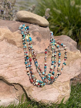 Load image into Gallery viewer, There is Turquoise, Coral, Hubble Glass Beads, Lapiz, Sterling Silver beads, and Stones all strung together on a braided 34&quot; rope.
